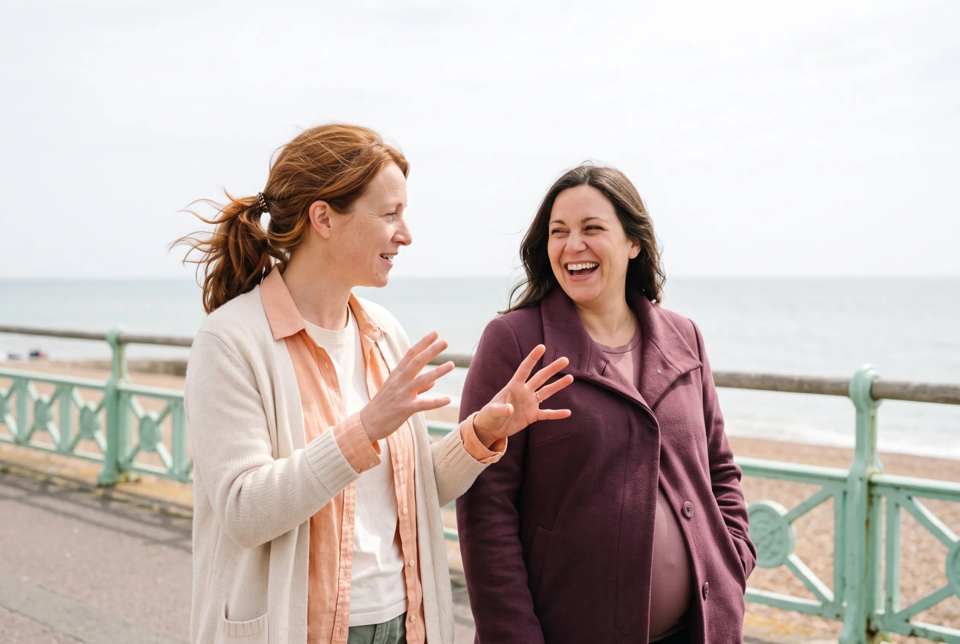 Holly Fraser walking with a pregnant client along the seafront in Brighton, photographed with the client's consent